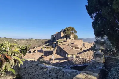 a view of a village with a stone wall at Village home in Ménerbes in Ménerbes