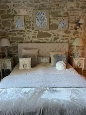 a bedroom with a large white bed with two tables at Village home in Ménerbes in Ménerbes