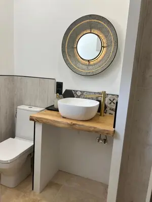 a bathroom with a sink and a mirror on a counter at Gîte en Provence pour amoureux de la nature in Rognes
