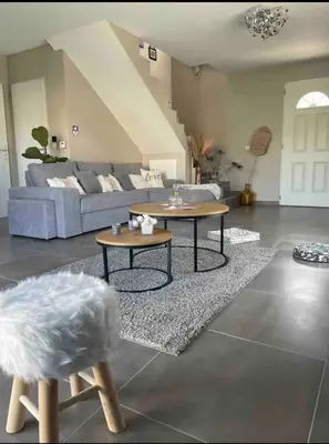 a living room with two tables and a couch at Chaleureuse maison in Cavaillon
