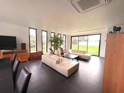 a living room with couches and a flat screen tv at Belvédère Sainte Victoire in Saint-Marc-Jaumegarde