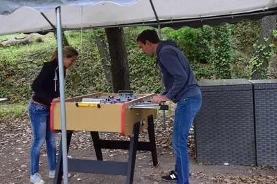 a man and a woman playing a game with a table at Moulin des Gypses Gîte l'Oliveraie, Ventoux in Mormoiron