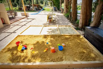 a sandbox with toys in the sand in a park at Appartement charmant près du centre d'Avignon, 60m², piscine in Avignon