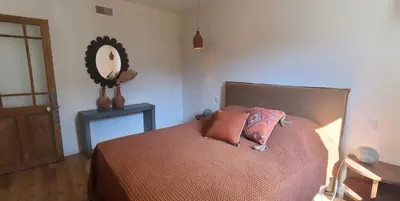 a bedroom with a bed with two pillows on it at Cycle , Cook and Relax in Caromb