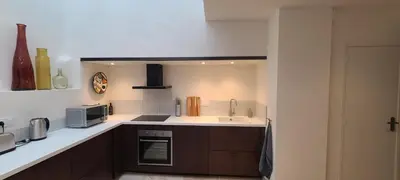 a small kitchen with a sink and a microwave at Cycle , Cook and Relax in Caromb