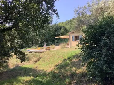 a house sitting on top of a grassy hill at Maison du vallon de Galeye in La Roque-sur-Pernes