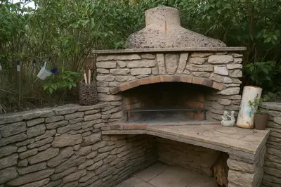 an outdoor brick oven sitting in a garden at Le Cabanon Provençal Traditionnel Jardin Barbecue & Cheminée in Saumane-de-Vaucluse