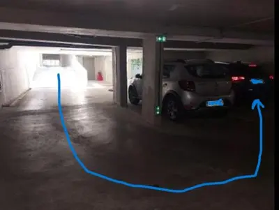 a car garage with a blue line on the floor at Au petit coeur de l'isle in LʼIsle-sur-la-Sorgue