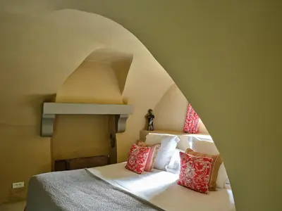 a room with two beds and a ceiling with an arch at Villa Syrah, La Bastide de Marie, Villa avec services in Ménerbes