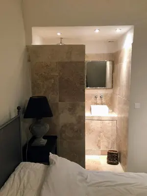 a bathroom with a sink and a mirror at La Cour Intérieure Ménerbes in Ménerbes