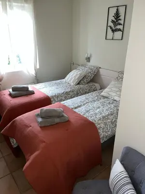 a bedroom with two beds with towels on them at Le Bastidon des Mésanges in Gordes