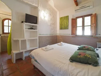 a bedroom with a white bed with two pillows at B&B Villa Chante Coucou in Fontaine-de-Vaucluse