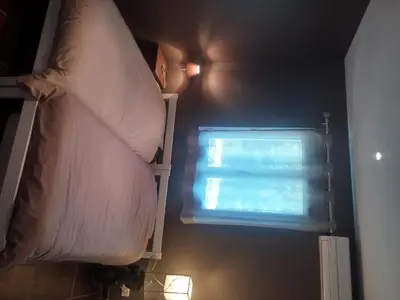 a bed with a pillow and a window in a room at B&B Villa Chante Coucou in Fontaine-de-Vaucluse
