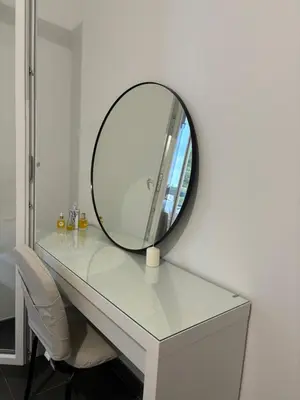 a mirror sitting on top of a white table at Appartement T2 climatisé garage in Aix-en-Provence