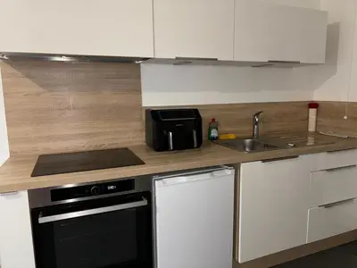 a kitchen with a sink and a counter top at Appartement T2 climatisé garage in Aix-en-Provence