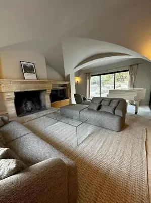 a living room with a couch and a fireplace at Bastide Farandole in Eygalières