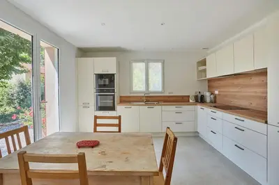 a kitchen with a wooden table with chairs and a dining room at Le Bastidon, Aix en Pce proche centre, climatisé, 4 chambres in Aix-en-Provence