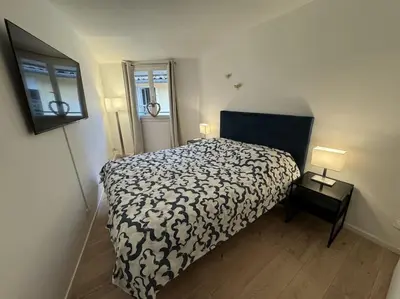 a bedroom with a bed with a black and white comforter at Duplex rénové comme Neuf à Aix-en-Provence in Aix-en-Provence