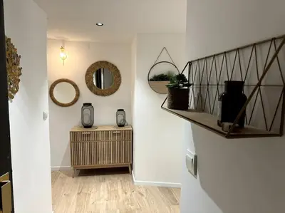 a hallway with a mirror on the wall and a table at Duplex rénové comme Neuf à Aix-en-Provence in Aix-en-Provence