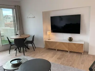 a living room with a large flat screen tv on a wall at Duplex rénové comme Neuf à Aix-en-Provence in Aix-en-Provence