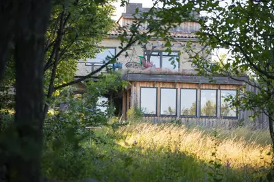 a house with a large window on the side of it at Ecolieu Silenciane in Simiane-la-Rotonde