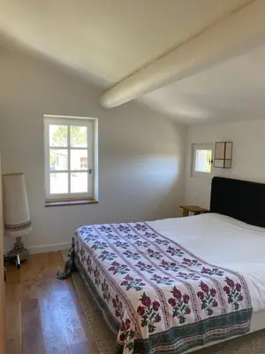 a bedroom with a bed and a window at Mas Au pays des Alpilles in Eygalières