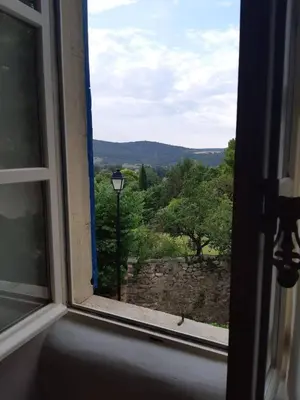 an open window with a view of a tree at Maison de village provençale in Monieux