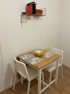 a wooden table with chairs and a yellow bowl on it at Appartement hyper centre climatisé in Salon-de-Provence