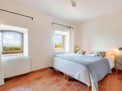 a bedroom with a bed and two windows at Holiday Home Villa Montagne by Interhome in Oppède