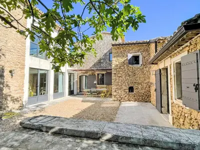 an exterior view of a stone house with a courtyard at Holiday Home Villa Montagne by Interhome in Oppède