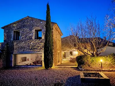 a large stone house with a tree in front of it at Holiday Home Villa Montagne by Interhome in Oppède