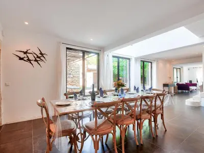 a dining room with a long table and chairs at Holiday Home Villa Montagne by Interhome in Oppède