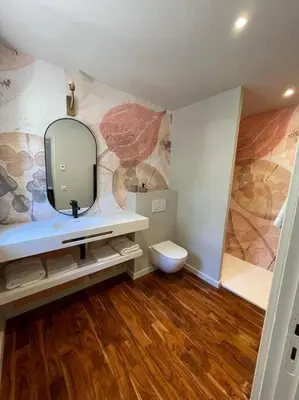 a bathroom with a sink and a mirror and a toilet at Domaine Farandole in Eygalières