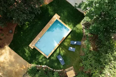 an overhead view of a swimming pool in the grass at Villa La Pinède in Aix-en-Provence