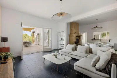 a living room with a couch and a table at Villa La Pinède in Aix-en-Provence