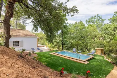 a yard with a swimming pool and a house at Villa La Pinède in Aix-en-Provence
