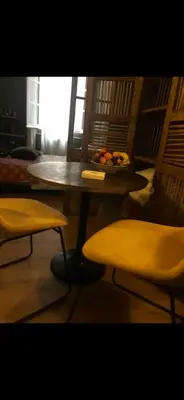 a table and chairs with a bowl of fruit on it at Chambre style balinais in Aix-en-Provence