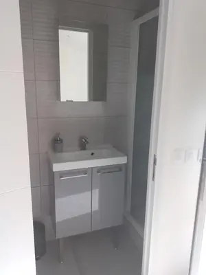 a white bathroom with a sink and a mirror at 2 Voyageurs - 1 Lit - Proche de toutes commodités in Peyrolles-en-Provence