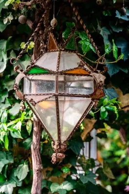 a street light hanging from a tree at La maison de la piscine in Goult