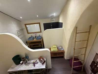 a bedroom with a bed and a desk and a chair at Moulin AURELIA in La Barben