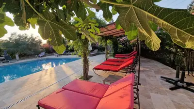 a large living room with a bed and chairs at Moulin AURELIA in La Barben