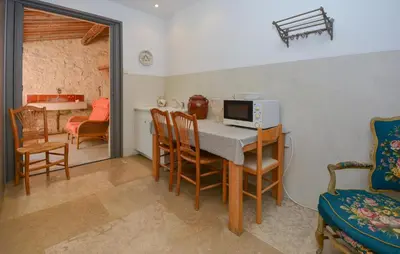 a kitchen and dining room with a table with a microwave at Stunning Home In Noves With Wifi in Noves