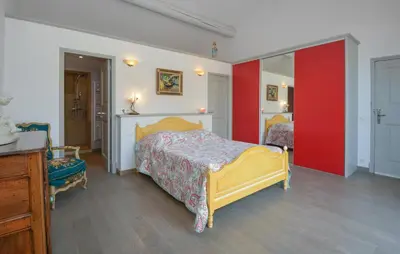 a bedroom with a bed and a red wall at Stunning Home In Noves With Wifi in Noves