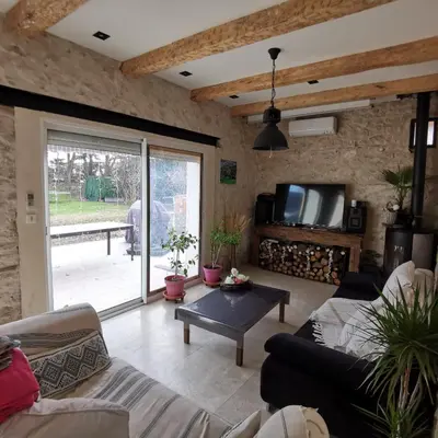 a living room with a couch and a tv at Maison Aix en Provence et grand jardin in Aix-en-Provence