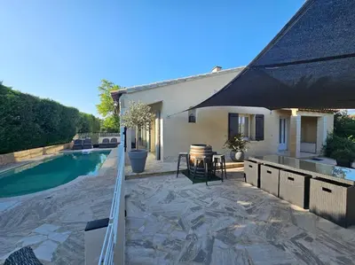 a backyard with a swimming pool and an umbrella at Paradise Corner in LʼIsle-sur-la-Sorgue