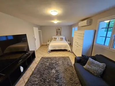 a living room with a bed and a couch at Paradise Corner in LʼIsle-sur-la-Sorgue