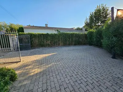 a backyard with a fence and a brick patio at Paradise Corner in LʼIsle-sur-la-Sorgue
