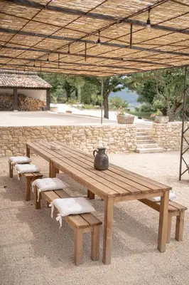 a wooden picnic table with a vase on top of it at Domaine de la Lisière in Sault-de-Vaucluse