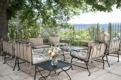 a group of chairs and a table on a patio at Domaine de la Lisière in Sault-de-Vaucluse