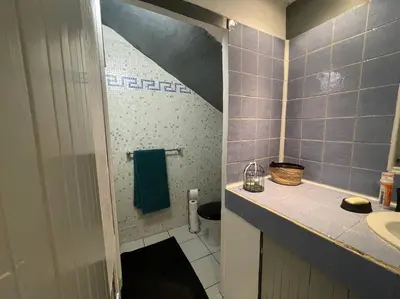 a bathroom with a sink and a toilet in it at Grand studio avec piscine au coeur du village in Le Puy-Sainte-Réparade